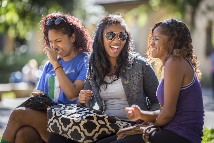 students laughing on bench