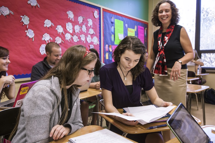 professor helping students in class