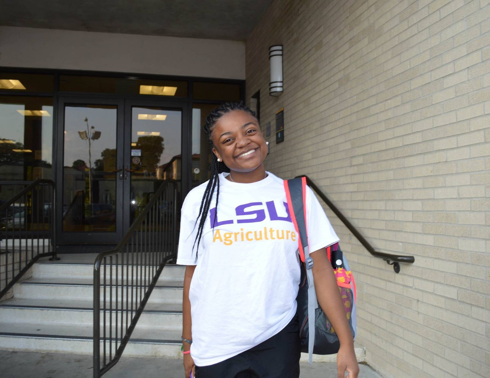 student smiles on steps