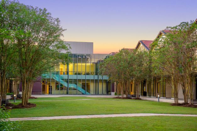 The BEC Auditorium building at dusk with purple sky.