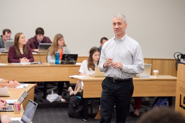 An LSU instructor speaks in front of a large classroom of students