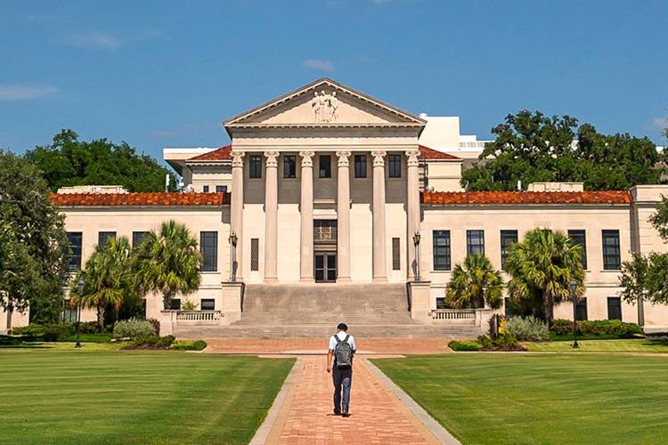 Student walking toward Law Building